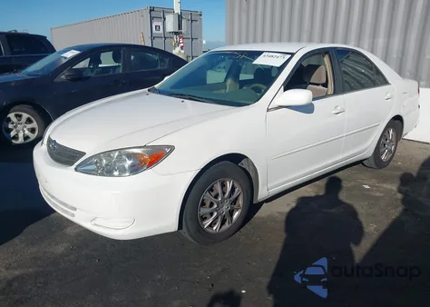 2003 Toyota Camry Le z USA, uszkodzony, nr VIN JTDBE32K730188966